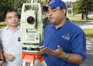 image- Students work with surveying equipment in a geomatics course at the University of Florida's Gulf Coast Research and Education Center's GCREC) Plant City, with Amr Abd-Elrahman, an associate professor of geomatics and principal investigator of the project. Photo courtesy UFIFAS Photography.