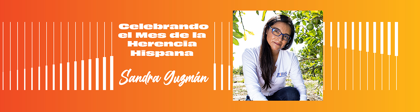 Orange and yellow banner reading “Celebrating Hispanic Month- Sandra Guzmán” with a photo of a woman with glasses in a citrus grove