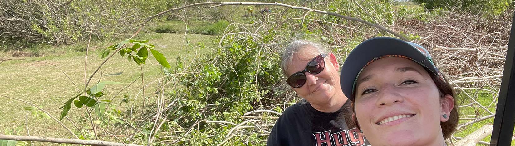 A picture after fieldwork, moving Brazilian pepper debris alongside Beth Curry