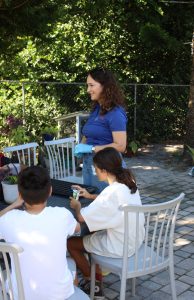 Salgado MacDonald standing outdoors, teaching children.