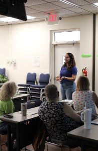 Salgado MacDonald instructing adults in a classroom setting