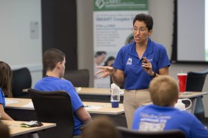 Nelly Nelson standing in a classroom, teaching.