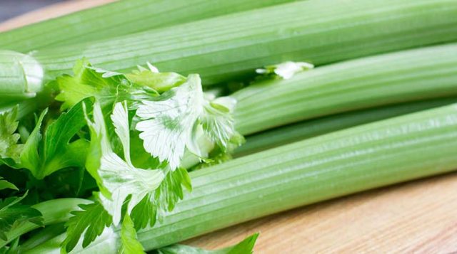 a stalk of lettuce on a cutting board. An Adobe stock image.