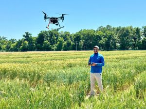 A UF/IFAS plant breeding Ph.D. graduate, flies a drone. Courtesy, Sudip Kunwar.