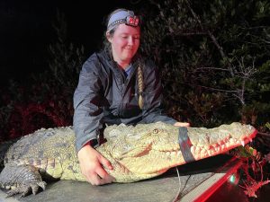 a. Bryna Daykin on an airboat during an American crocodile capture survey b. Photo credit: UF/IFAS Croc Docs