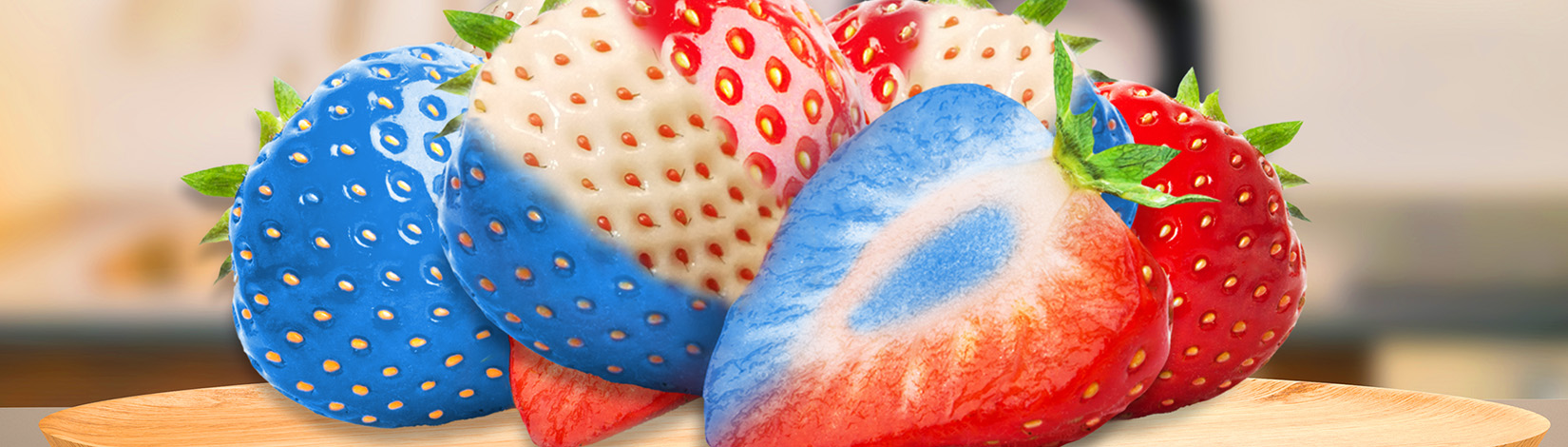Red, white and blue strawberries on a kitchen counter