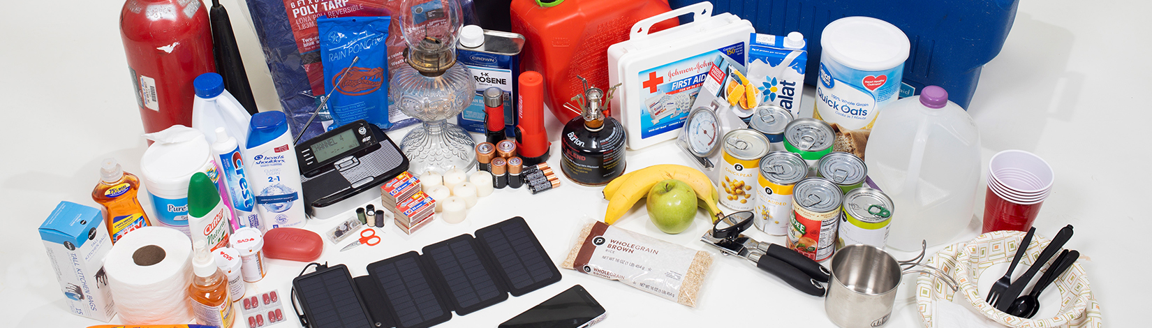 A complete display of items typically found in a hurricane kit, including food, water, flashlight, batteries, first aid supplies and other emergency essentials