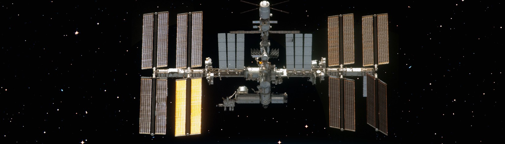 International Space Station ISS over planet Earth. Adobe Stock by muratart.