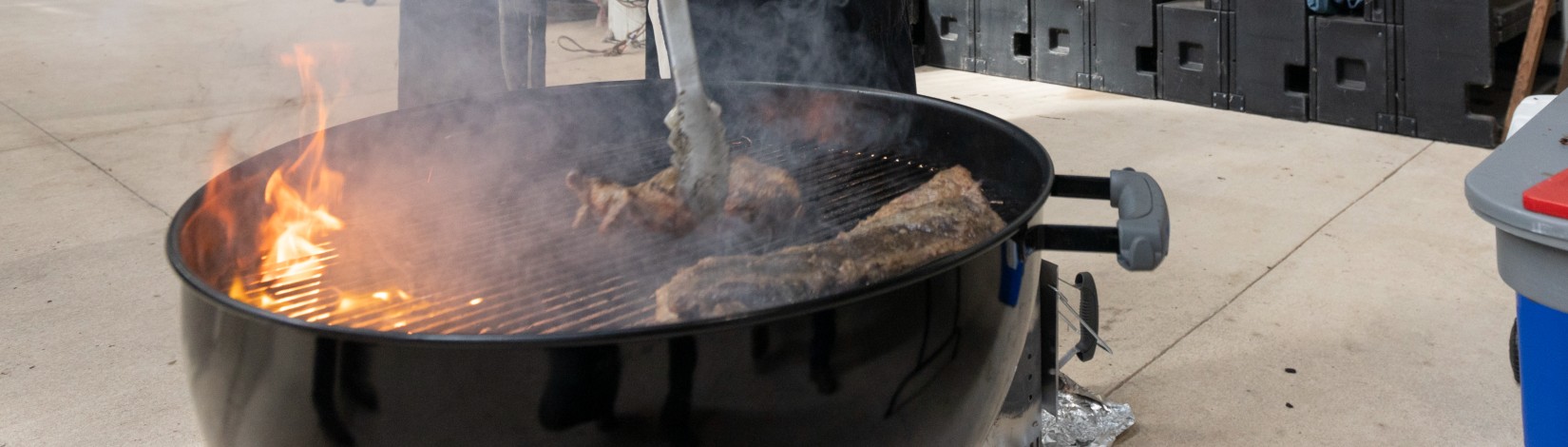 Animal Sciences faculty Chad Carr cooking mutton on a grill. Photo: UF/IFAS, Tyler Jones