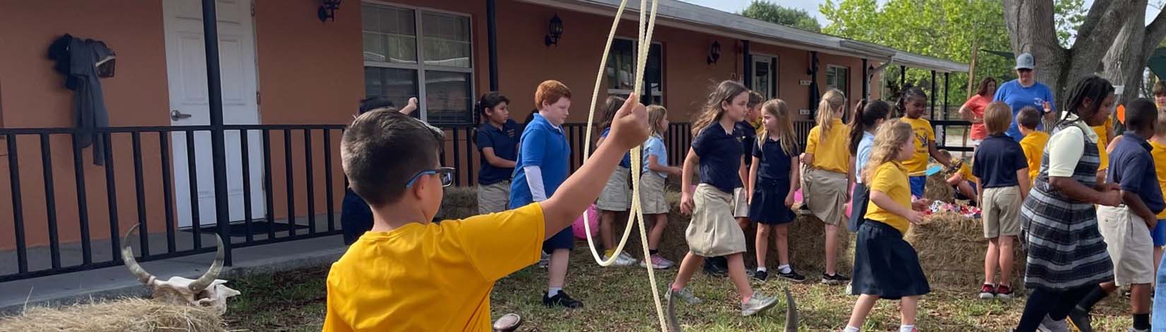 A youth is given instruction on roping technique.