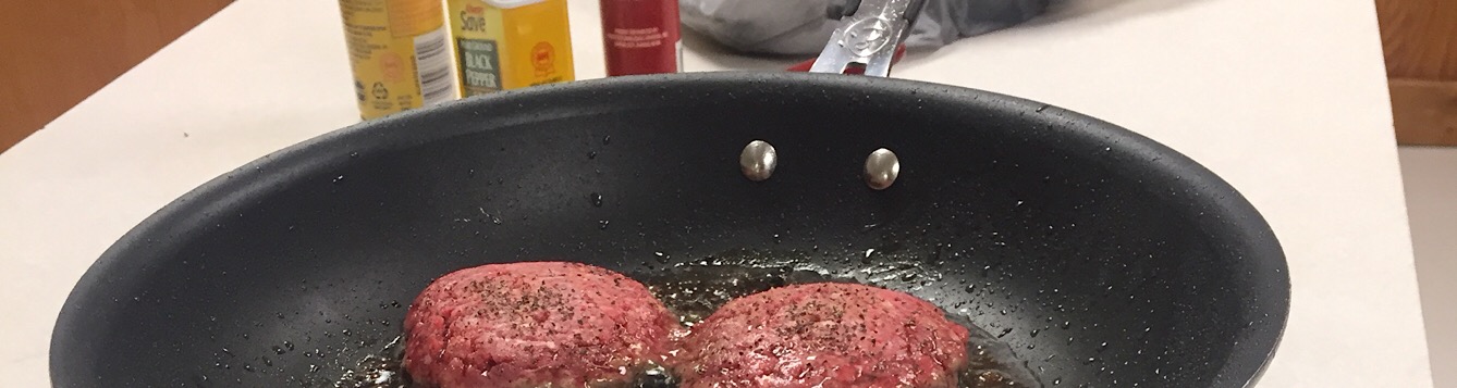 picture of burgers cooking in a pan