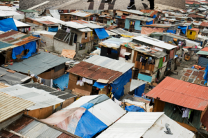 Informal settlement showing houses made out of cardboard, rusted steel roof panels, and plastic