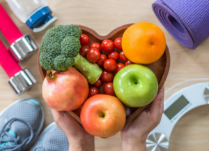 vegetables in heart shaped bowl with fitness items