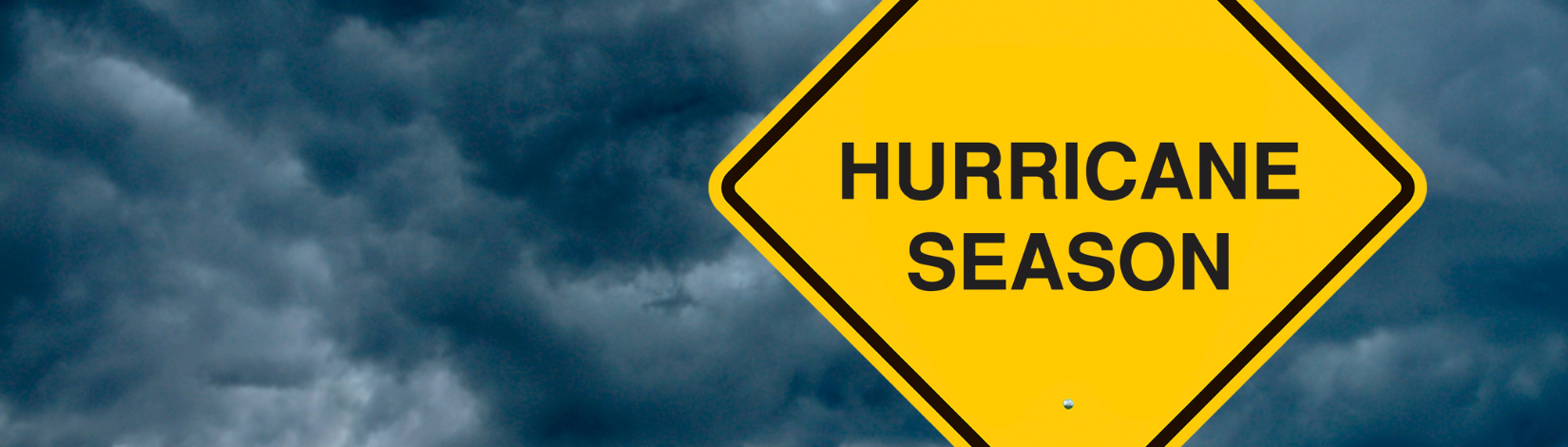 dark blue stormy sky with a yellow hurricane season sign