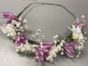 A flower crown with alternating white and purple flowers