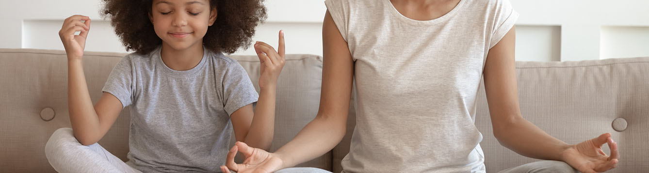 Mother and daughter doing yoga