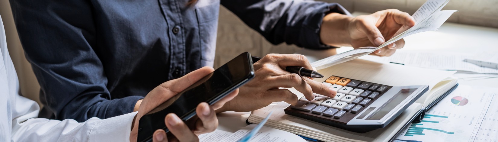 Stressed young couple checking bills, taxes, bank account balance and calculating expenses in the living room at home.