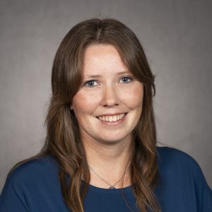 Women with long brown hair smiling 