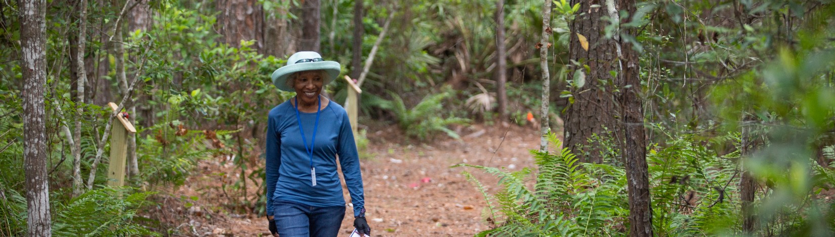 Woman walking nature trail.
