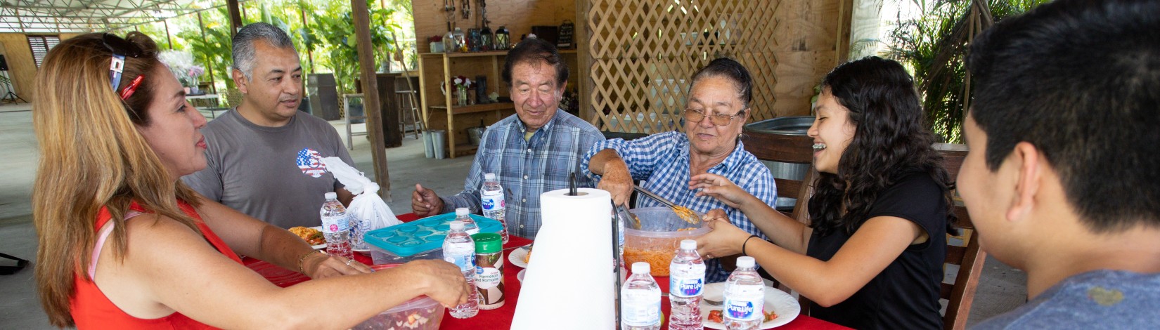Nixia Martinez (left in red) and her family having lunch together.