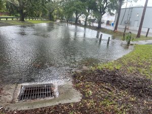 A storm drain surrounded by water