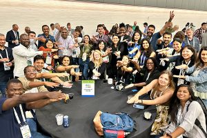 large group of people with their arms out doing the "gator chomp"