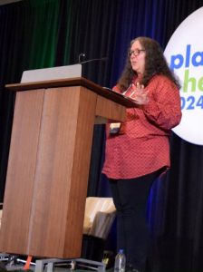 karen garrett speaking behind lectern