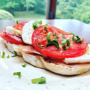 Tomato and mozzarella open faced sandwich on bread