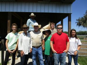 group picture with ranch owners and kids
