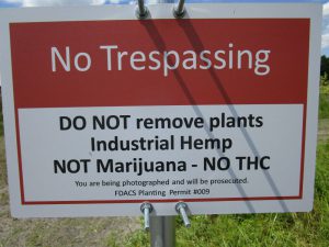 Restrictive sign posted on protective fence around the crop