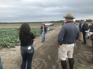 woman talking to audience about cabbage plasticulture trial