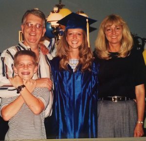 Female high school graduate with family