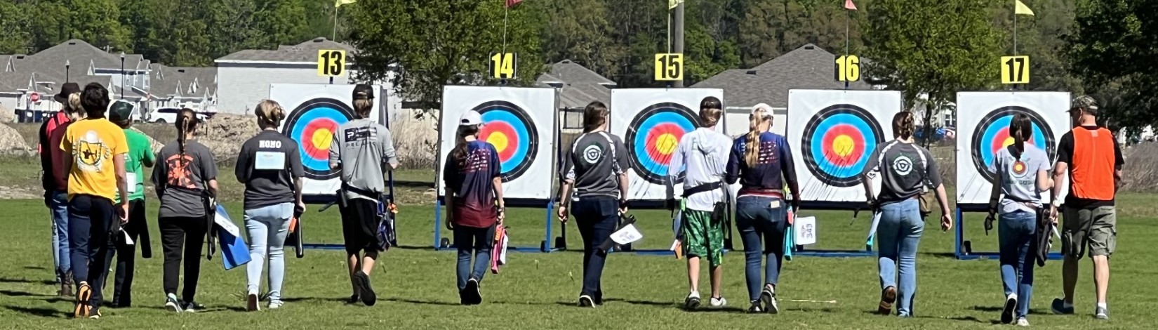 Youth archers walking to FITA targets.