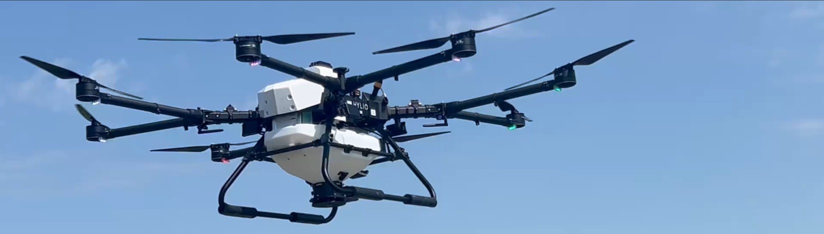 advanced drone flying with sky and farm field in background