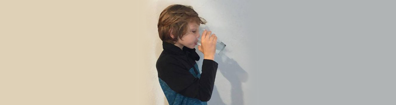 boy drinking water from glass