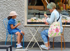 a mother and daughter eat ice cream cones outside a shop. [pixabay.com, mircea allin collections]