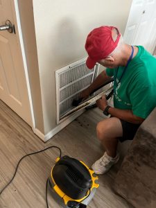 Energy Coach volunteer cleans an air filter