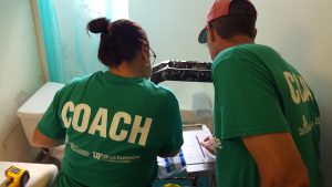 Two Energy Coach Volunteers during an "Energy Sweep" or efficiency upgrades at Sarasota Housing Authority