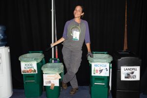 Tracie Troxler with the nonprofit Sunshine Community Compost collecting and sorting food waste at the EcoSummit.