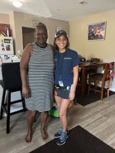 Sustainability staff and a resident of a low-income housing resident that received efficiency upgrades.