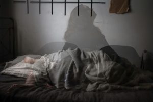 photo-illustration of a woman having difficulty sleeping in bed. [credit: unsplash.com, megan te boekhorst]