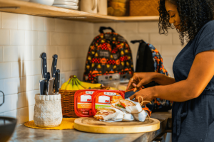 a woman prepares sandwiches at a kitchen countertop. [credit: unsplash.com, hillshire farm]
