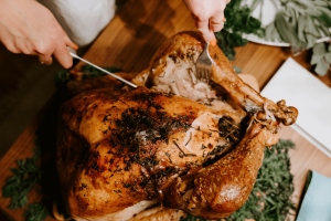 carving a turkey on a cutting board. [credit: unsplash.com, claudio schwarz]