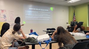 Sustainability staff teaching a solar energy class to youth at a Girls Inc summer camp.