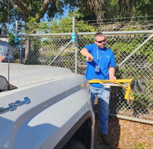 MMS technician shows off distribution arms on county vehicle