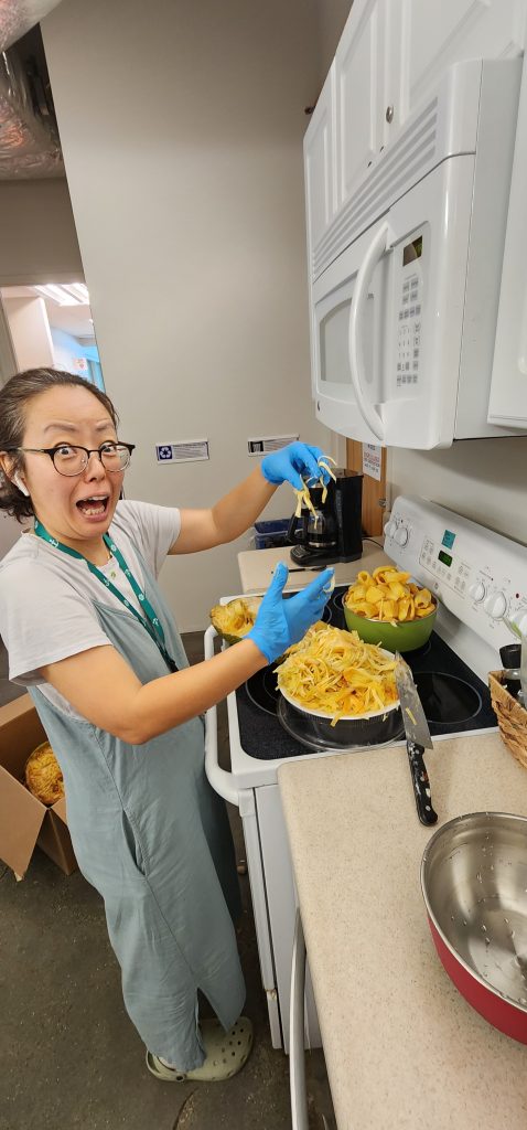 Zoe, our Family Nutrition Program Assistant helping process this huge fruit.
