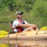 An image of a man kayaking in a river.