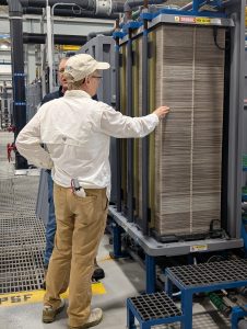 a participant during a t. mabry carlton water treatement facility tour looks closely at the electrodialysis reversal stacks, each of which contains 500 and 1,200 individual membranes