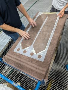 closeup of hands of two individuals checking the membranes used in an electrodialysis reversal system