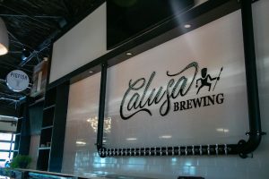 sign at Calusa Brewing over the bar.